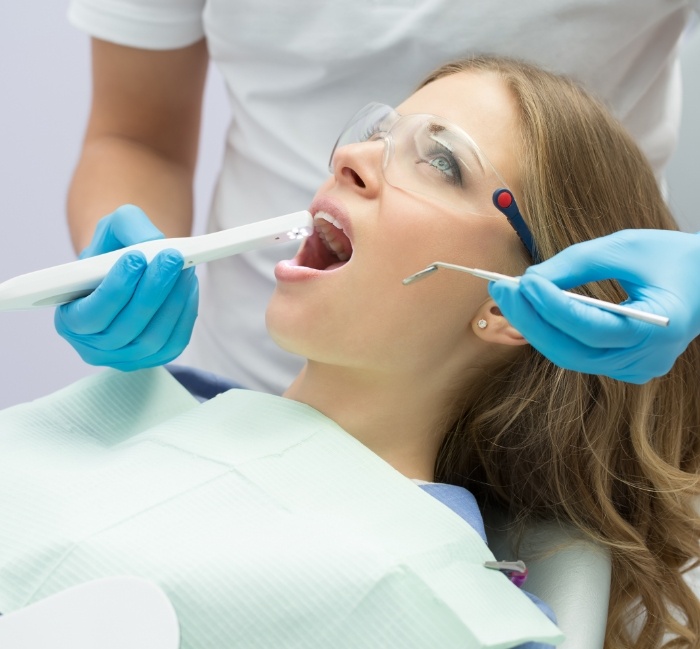 Dentist using intraoral camera to capture smile images