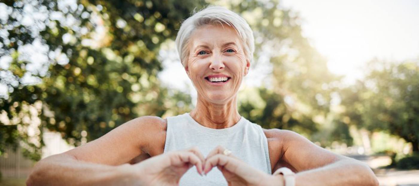 Lady makes shape of heart with her hands