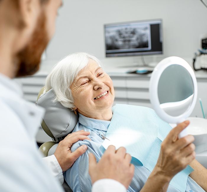 Older female patient in dentist’s chair