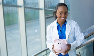Dentist holding a piggy bank