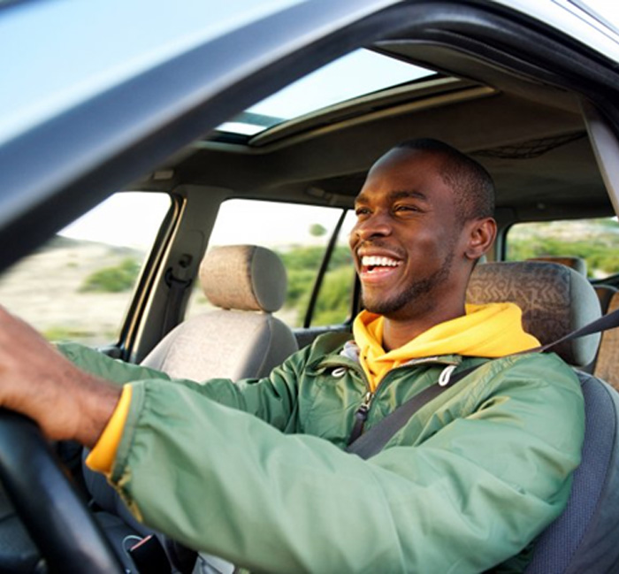 Man smiles while driving