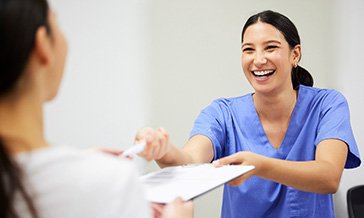Dental receptionist assisting patient with financial options