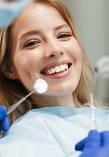woman smiling while getting dental checkup 