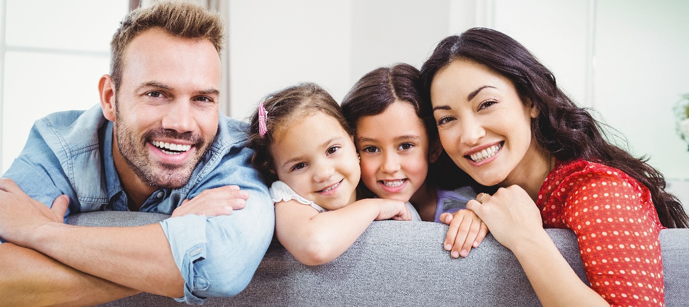 Family smiling after a visit with their MetLife dentist in Oak Point