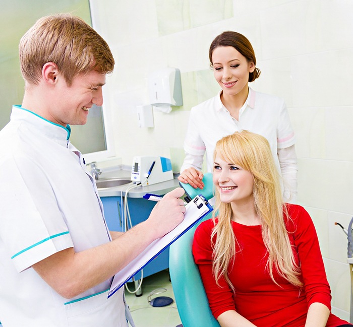 Woman smiling at dental staff member