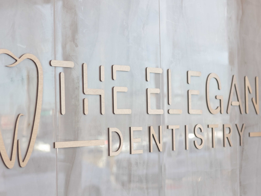The Elegant Dentistry logo on a window