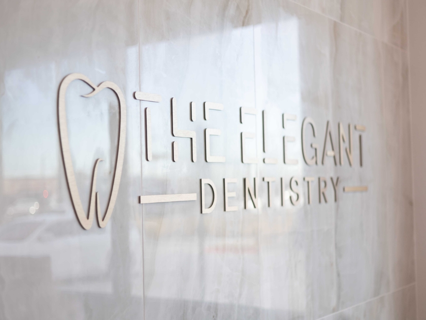 The Elegant Dentistry sign on dental office wall