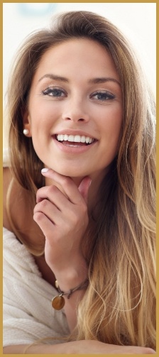 Woman smiling with hand on chin