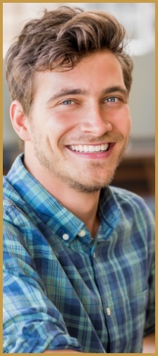 Man in button-up shirt smiling
