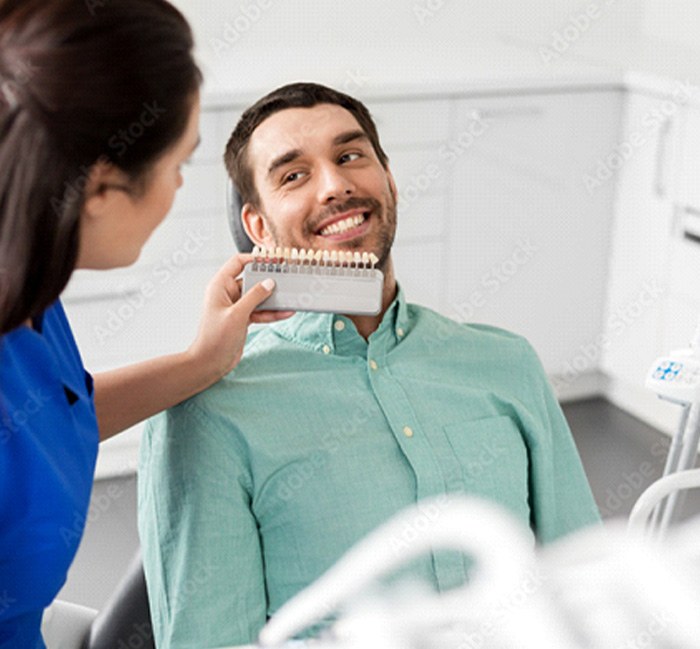 dental patient choosing how white he wants his teeth to be.