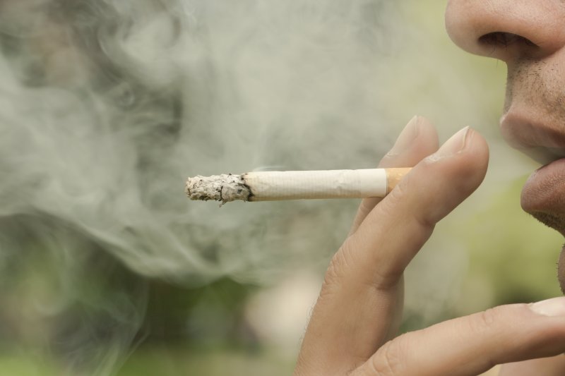 grayscale image of someone smoking