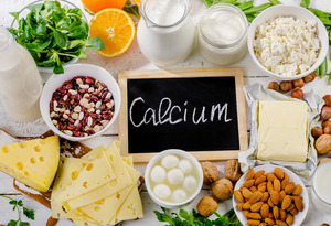 Chalkboard reading “calcium” surrounded by calcium-rich foods